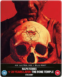 Movie steelbook cover with a person holding a skull against a red background